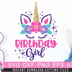May include: A white t-shirt with a pink unicorn head with a gold horn and purple and blue flowers. The text "Birthday Girl" is below the unicorn head with pink and purple stars.