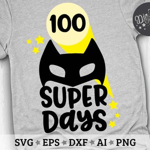 May include: A gray t-shirt with a yellow and black superhero design. The design includes a yellow star, a yellow circle with the number 100 inside, and a black superhero mask. The text "SUPER DAYS" is written in black below the mask.