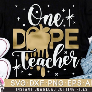 May include: Black t-shirt with white text that reads "One Dope Teacher" with a gold dripping design. The design is a stylized hand with a dripping effect.