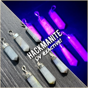 May include: Seven Hackmanite crystal pendants, each with a silver bail. The pendants are a light blue color under normal light, but glow a bright purple under UV light. The text "Hackmanite UV Reactive!" is superimposed on the image.