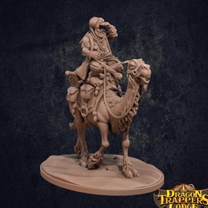 May include: A miniature figurine of a man riding a camel. The man is wearing a turban and a long robe. The camel is brown and has a saddle. The figurine is made of a light brown material and is painted in a realistic style. The figurine is on a base that is shaped like a desert landscape. The text "The Dragon Trappers Lodge" is visible in the lower right corner of the image.