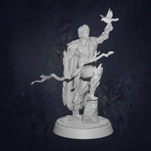 May include: A white figurine depicting a figure holding a bird. The figure is in armour and stands on a rocky base, with a staff. The figurine is on a circular base. The overall design is highly detailed.