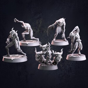 May include: Five miniature figurines of demonic creatures, each standing on a round base. The figures are painted in a light grey colour and have various poses and expressions.