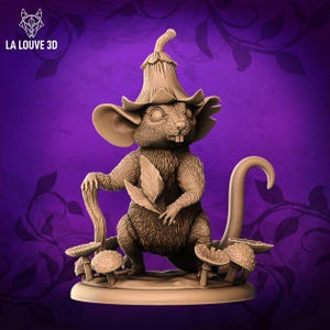 May include: A brown, sculpted figurine of a mouse wearing a mushroom-shaped hat and holding a leaf. The mouse is standing on a base with mushrooms around it.