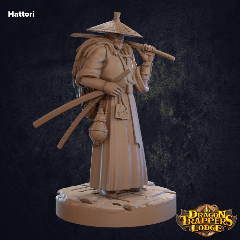 May include: A painted miniature figurine of a warrior wearing a straw hat and a long robe, holding a sword. The figurine is standing on a stone base. The text "Hattori" is visible in the top left corner of the image.