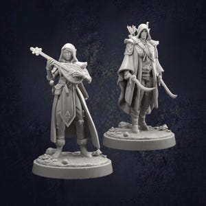 May include: Two grey miniature figurines of fantasy characters. One figure holds a lute, wearing a hooded cloak and tunic. The other figure is armed with a bow and a curved blade, also wearing a hooded cloak.