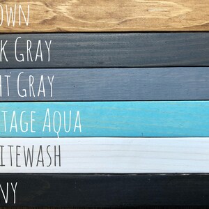 May include: Six wood samples stained in different colors: brown, dark gray, light gray, vintage aqua, whitewash, and ebony.