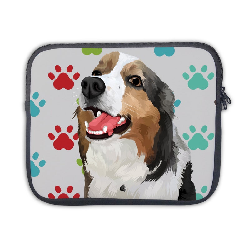 May include: A laptop sleeve with a colorful paw print pattern and a cartoon image of a dog with brown, black, and white fur. The dog is smiling with its tongue sticking out.
