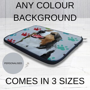 May include: A personalized laptop sleeve with a colorful paw print design and a cartoon dog illustration. The sleeve is available in three sizes. "Any Colour Background" and "Comes in 3 Sizes" are written on the image.