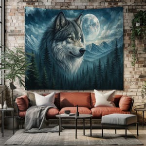 May include: A tapestry featuring a detailed portrait of a gray wolf against a backdrop of a forest, mountains, and a full moon. The artwork is rendered in shades of blue, gray, and white, creating a serene, natural scene. The tapestry is displayed on a brick wall.