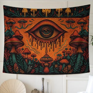 May include: A tapestry featuring a vibrant, psychedelic design. The artwork showcases a large, stylized eye with dripping details, surrounded by colorful mushrooms and foliage. The color palette includes orange, red, green, and black.