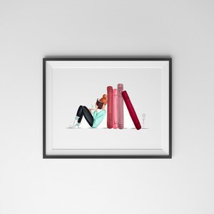 May include: A framed art print featuring an illustration of a person reading a book while leaning against a stack of books. The person is wearing a light blue sweater, black pants, and white boots. The books are various shades of red and pink.