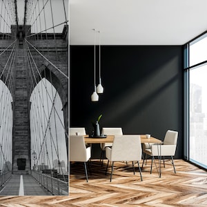 May include: Black and white photo of the Brooklyn Bridge in New York City. The photo is used as a wall mural in a modern dining room with a wooden table and chairs.