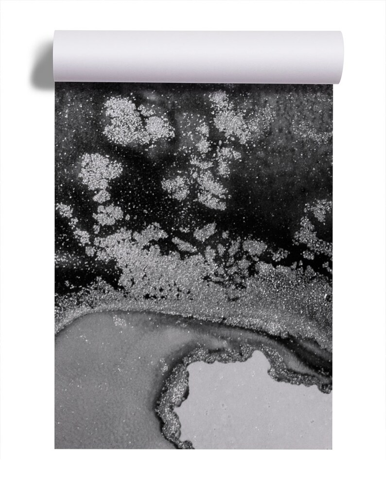 May include: Abstract black and silver glitter art print. The print features a swirling design with silver glitter accents on a black background.