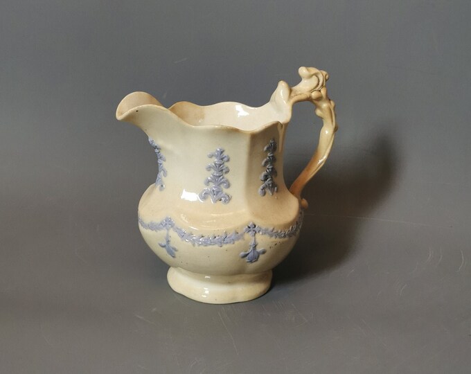 Antique French porcelain jug, design of swags and fleur-de-lis.