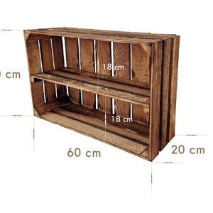 May include: A rustic, wooden crate-style shelf unit. The unit is stained a warm brown and features two shelves. It measures 23.6 inches wide, 15.7 inches high, and 7.9 inches deep. The shelves are 7 inches apart.