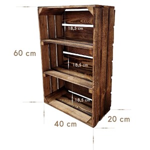 May include: A rustic, wooden crate-style shelf unit. The unit is stained a dark brown and features three shelves. The overall dimensions are 23.6 inches high, 15.7 inches wide, and 7.9 inches deep. Each shelf is 7.3 inches deep.