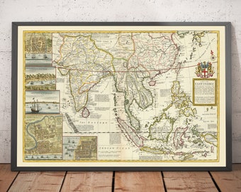 May include: An antique map of the East Indies, printed in brown, red, and green ink on a cream-colored background. The map shows the islands of Southeast Asia, including Java, Sumatra, Borneo, and the Philippines. The map is framed in a black frame.