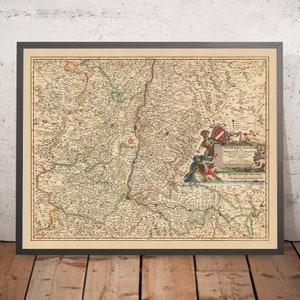 May include: An antique map of the region of Alsace, France, printed in 1700. The map is in a brown frame and shows the borders of the region, rivers, and towns. The title of the map is "SUPERIORIS ALSATIAE PRINCIPATUS ET COMITATUS", and the map is decorated with a coat of arms and a figure of a knight.