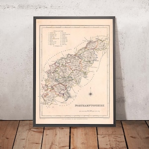 May include: An antique map of Northamptonshire, England, with a detailed outline of the county's borders and a key listing the names of towns and villages. The map is printed on cream-coloured paper with brown, red, and green lines and text.