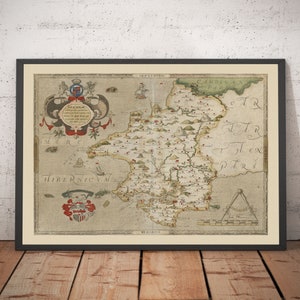 May include: An antique map of Ireland, printed in black and white with hand-painted details in red, green, and blue. The map shows the counties of Ireland with their names and coats of arms. The map is surrounded by a decorative border.