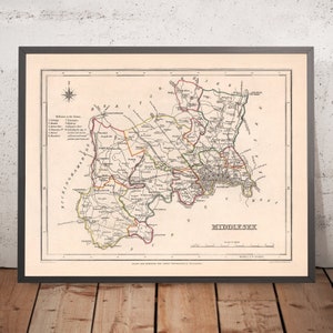May include: Framed antique map of Middlesex, England, showing roads, towns, and geographical details. The map, in a black frame, includes a compass rose and text. Printed on aged paper, it's a historical cartographic piece.