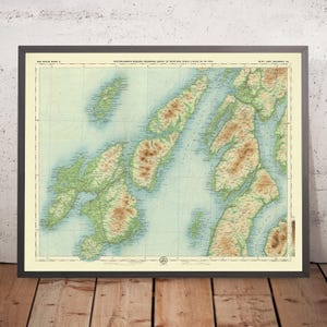 May include: A vintage map of the Isle of Skye, Scotland, with a light blue background and green and brown topographical features. The map is titled "Bartholomew's Reduced Ordnance Survey of Scotland Scale 1 Mile to 1 Inch."