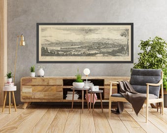 May include: A black framed vintage map print of the city of  "Grand" with the text "Prospect du Grand dit de Triante" in the top left corner. The map is displayed on a wall above a wooden entertainment center with a lamp and plants.