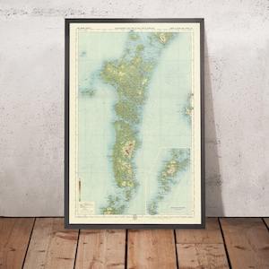 May include: A vintage map of the Philippines, printed on a light blue background with green and brown markings. The map shows the islands of Luzon, Visayas, and Mindanao. The map is framed in a black frame.