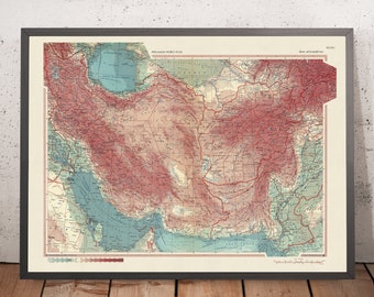 May include: A vintage map of Iran, Afghanistan, and parts of surrounding countries. The map is printed on cream-coloured paper and features a colour-coded elevation system. The map is framed in a dark grey frame.