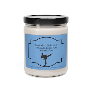 May include: A 9 ounce soy candle with a blue label that says "Strike First, Strike Hard: The candle doesn't burn without a flame". The label also features a silhouette of a person doing a karate kick.