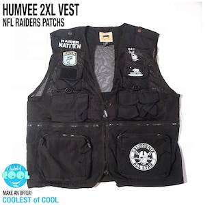 May include: A black Humvee 2XL utility vest featuring multiple pockets, a front zipper closure, and various patches including Raider Nation, Bass, California Republic, and a circular California All Star Raider Nation patch on the lower right pocket.