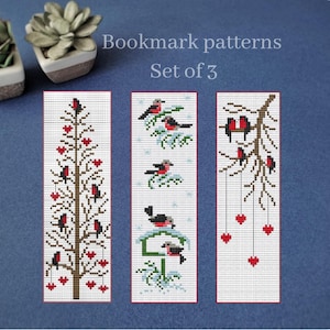 Puede incluir: Juego de 3 patrones de marcapáginas con diseños de punto de cruz. Los marcapáginas representan pájaros en ramas y árboles, con detalles de corazones rojos. El texto "Bookmark patterns" y "Set of 3" es visible.
