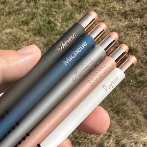 May include: Six personalized pens with rose gold accents and different colored barrels. The names "Theresa", "Michelle", "Madison", "Barbara", "Brandy", and "Payton" are engraved on the pens.