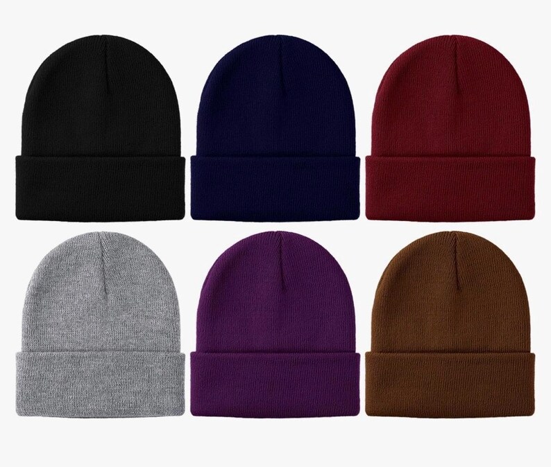 May include: Six different colored knit beanies. The beanies are all the same style, with a fold-over cuff. The colors are black, navy blue, burgundy, gray, purple, and brown.