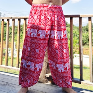 May include: Red and white patterned pants with an elephant design. The pants have a drawstring waist and a loose, comfortable fit. The fabric appears to be lightweight, suitable for warm weather.
