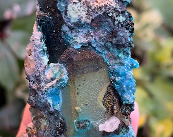 May include: A rough, irregularly shaped, blue, green, and black crystal with a white, crystalline texture.