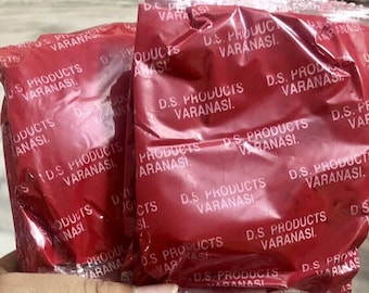 May include: Multiple red plastic bags with the text "D.S. Products Varanasi" repeated on each bag.
