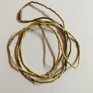 May include: A long strand of light brown wooden beads with a gold metal clasp.