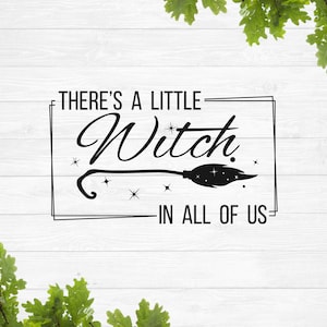 May include: Black and white sign with the text "THERE'S A LITTLE Witch IN ALL OF US" and a witch's broom. The sign is rectangular with a black border and star accents. The background is a white wooden surface.