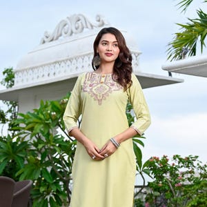May include: A light green kurta and palazzo set with embroidered detailing. The kurta has a round neckline and three-quarter sleeves. The palazzo pants have a straight leg and are ankle-length.