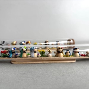 Miniature Nativity scene in a horizontal bottle.