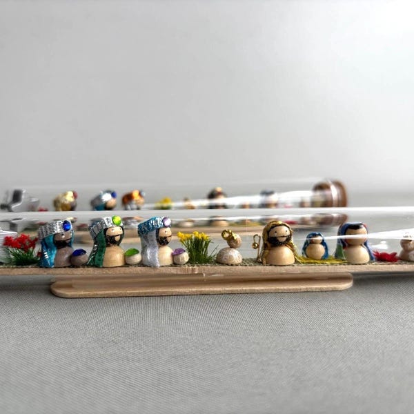 Miniature nativity scene inside a horizontal bottle.