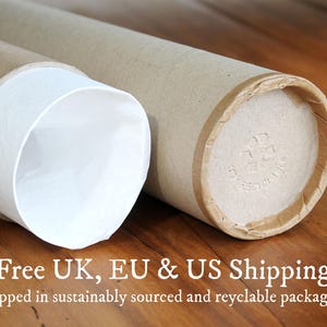 May include: Two cylindrical cardboard shipping tubes with light brown exterior surfaces. One tube is open, revealing a white interior lining, while the other is closed with a circular cardboard cap featuring a stamped recycling symbol.