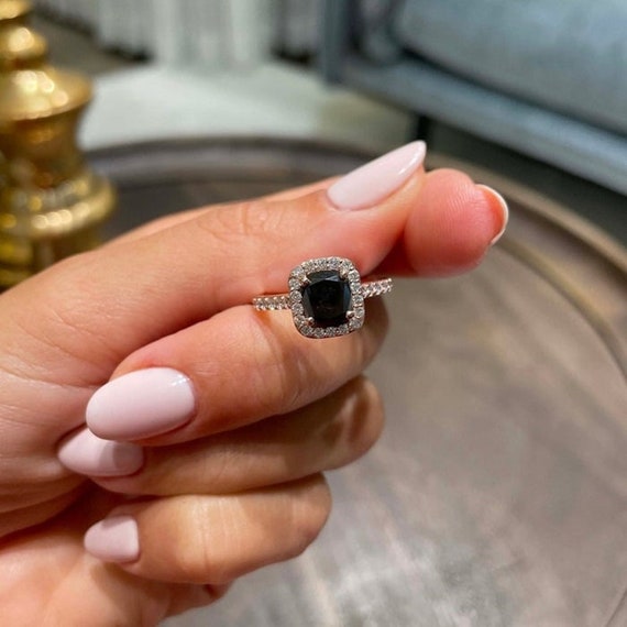 Premium Photo | A fancy gold ring with diamonds and a black stone on the  top.
