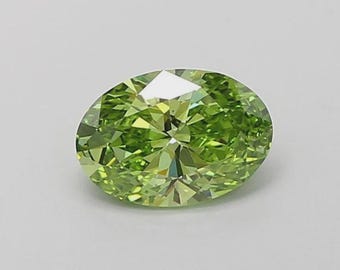 May include: An oval-shaped, faceted gemstone in a vivid, light green colour. The gem has a bright, reflective surface, with numerous facets that capture and reflect light. The gemstone is set against a plain, light background.