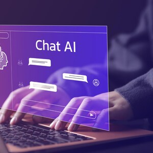May include: A person using a laptop with a screen displaying "Chat AI". The screen has a purple gradient background with white icons and text bubbles. The person's hands are on the keyboard.