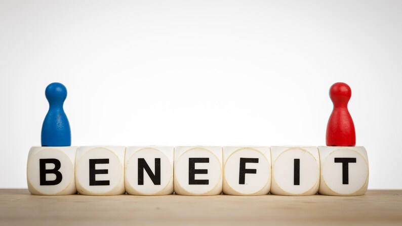 May include: A conceptual image featuring the word "BENEFIT" spelled out with white letter blocks. A blue game piece sits atop the "B", and a red game piece sits atop the "T". The background is white.