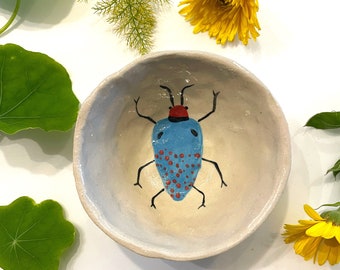 Sauce bowl with blue insect