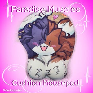 May include: Cushion mousepad with a cartoon cat design. The mousepad features a purple, brown, and white cat illustration with the text "Paradise Muscles" and "Cushion Mousepad". The mousepad has a wrist rest.